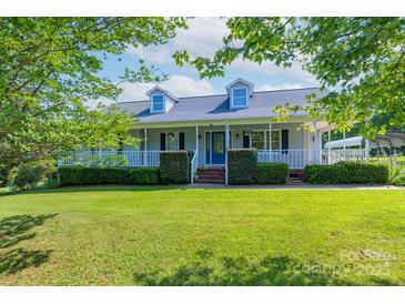 Charming home with a welcoming front porch and well-manicured lawn and blue door at 5211 Spring Gln, York, SC 29745
