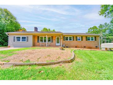 Charming brick home featuring a cozy front porch and lush green lawn at 701 Mcswain Rd, Shelby, NC 28150