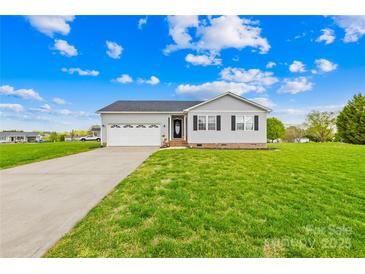 Charming single-story home with lush green lawn and attached two car garage at 103 Chambwood Ln, Shelby, NC 28152