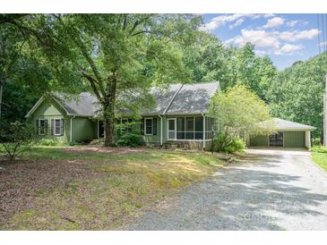Charming single-story home featuring a screened porch and a detached two-car garage at 114 Larkfield Dr, Waxhaw, NC 28173