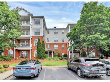 Beautiful condo complex with brick facade, manicured landscaping, and ample parking at 14451 San Paolo Ln, Charlotte, NC 28277
