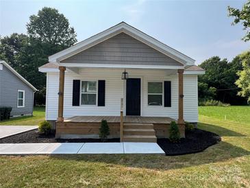 Charming single story home featuring a cozy front porch and fresh landscaping at 210 Marshall St, Rock Hill, SC 29730