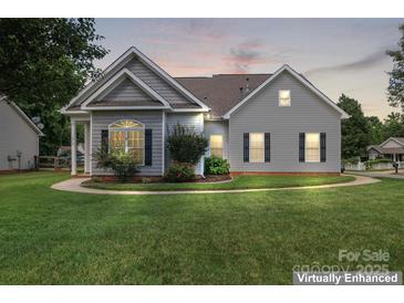 Charming single-story home features a well-manicured lawn and traditional architectural details at 219 Mccord St, Charlotte, NC 28216
