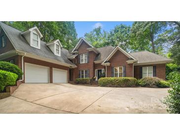 Charming brick home with a well-maintained front yard, a three-car garage, and a spacious driveway at 23 Tanglewood Rd, Clover, SC 29710