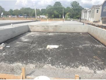 New home foundation under construction in a community with modern townhomes at 2927 Herringbone Rd # 41, Charlotte, NC 28208