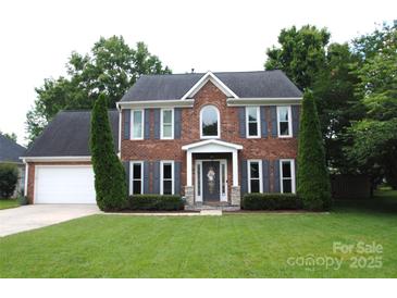 Traditional two-story brick home with well-manicured lawn and attached two-car garage at 3905 Brittany Ct, Indian Trail, NC 28079