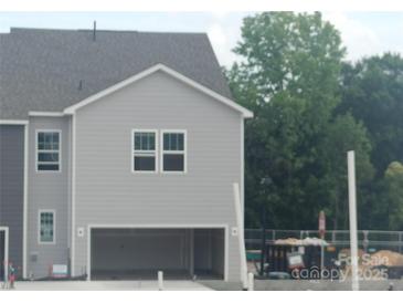 New two-story home featuring gray siding and an attached two-car garage at 4143 Walking Ridge Rd # 49, Charlotte, NC 28208