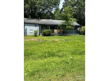 Cozy single-story home with a covered front porch and mature landscaping at 4914 Friendship Dr, Matthews, NC 28105