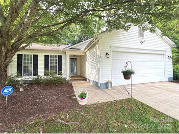 Charming single-Gathering home featuring white siding, a well-manicured lawn, and a two-car garage at 5434 Starflower Dr, Charlotte, NC 28215