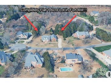 Aerial view of a flat one-acre lot in Fort Mill, featuring mature trees and beautiful surrounding homes at 908 Haddonfield Dr, Fort Mill, SC 29708
