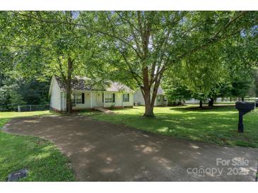 Charming single-story home featuring a driveway and well-maintained front yard with mature trees at 1013 Ashwood Pl, Salisbury, NC 28146