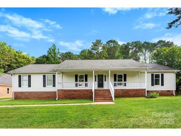 Charming single-story home with a welcoming front porch and well-manicured lawn at 118 Creek Hollow Trl, Belmont, NC 28012