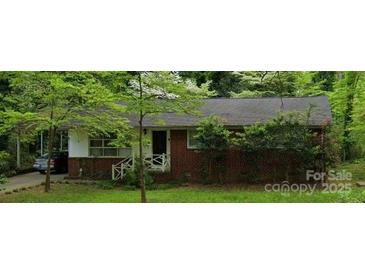 Charming brick home with a covered carport and well-manicured front yard at 1332 Midwood Dr, Gastonia, NC 28052