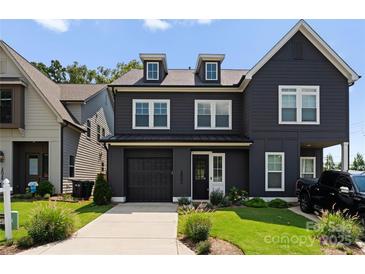 Modern two-story home featuring a front-entry garage and manicured lawn at 2600 Mason Cir # A, Charlotte, NC 28205