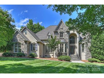 Beautiful stone-and-stucco home with manicured lawn, mature trees and covered front entry at 3284 Millstone Creek Rd, Lancaster, SC 29720