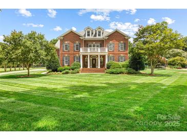 Beautiful brick home with manicured lawn and lush landscaping at 3706 Song Sparrow Dr, Matthews, NC 28104