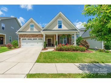 Charming two-story home with manicured lawn, brick accents, and a two-car garage at 385 Willow Tree Dr, Rock Hill, SC 29732