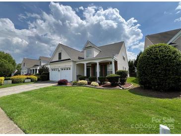 Charming home with a well-manicured lawn, a two-car garage, and lovely landscaping at 5238 Prosperity View Dr, Charlotte, NC 28269