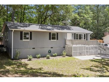 Charming home featuring a quaint front porch and gray exterior paint at 613 Davis St, Lancaster, SC 29720