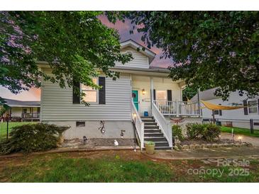 Charming home featuring a quaint front porch and well-maintained landscaping at 805 Caldwell St, Belmont, NC 28012