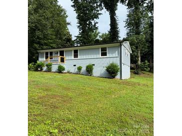 Charming single-story home featuring a combination of painted brick and siding and a well manicured front yard at 10514 Harbor Dr, Charlotte, NC 28214