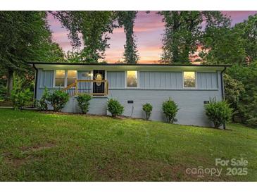 Twilight view of updated single story home in the evening, complemented by mature trees at 10514 Harbor Dr, Charlotte, NC 28214