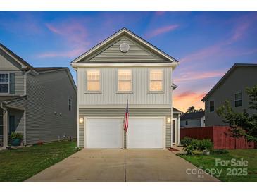 Charming two-story home with a two-car garage and an American flag waving in front at 12522 Palomino Dr, Midland, NC 28107