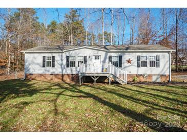 Charming single-story home featuring white siding, brick foundation, covered entry and a well-manicured front lawn at 3433 Spinner Ct, Sherrills Ford, NC 28673
