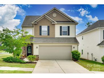 Charming two-story home featuring a two-car garage, landscaped yard, and mixed siding at 505 Silers Bald Dr, Fort Mill, SC 29715