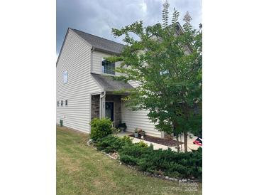 Charming two-story home featuring stone accents, a well-manicured lawn, and lovely landscaping at 505 Silers Bald Dr, Fort Mill, SC 29715