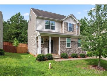 Charming two-story home with stone accents, a cozy front porch, and a well-maintained lawn at 231 Anvil Draw Pl, Rock Hill, SC 29730
