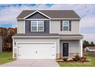 Charming two-story home with gray siding, a two-car garage, and a well-maintained lawn at 3315 Burberry Dr, Gastonia, NC 28052