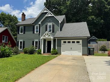 Charming two-story home with a well-manicured lawn, attached garage, and craftsman details at 4221 Hounds Run Dr, Matthews, NC 28105