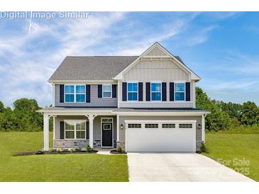 Charming two-story home with a manicured lawn, two-car garage and lovely curb appeal at 490 Lenswood Ct, Denver, NC 28037