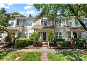 Inviting townhome featuring well-manicured landscaping, front porch, and charming curb appeal at 8310 Brickle Ln, Huntersville, NC 28078