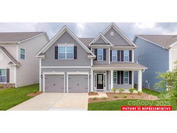 Charming two-story home featuring a two-car garage and landscaped front yard at 112 Fordingbridge Ln, Mooresville, NC 28115