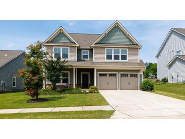 Charming two-story home featuring a two-car garage, well-manicured lawn, and inviting curb appeal at 2720 Watergarden St, York, SC 29745