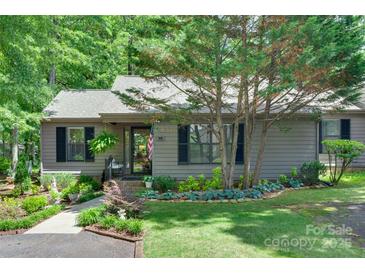 Charming single-story home featuring a well-manicured front yard with mature trees and lush landscaping at 353 Tall Oaks Trl, Fort Mill, SC 29715