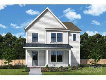 Charming two-story white home with a covered porch and beautifully landscaped front yard at 6124 Littleroot Way, Charlotte, NC 28278