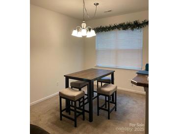 Cozy dining area featuring a table with four chairs and a modern chandelier above at 13116 Erwin Rd, Charlotte, NC 28273