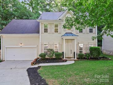 Charming two-story home featuring a well-manicured lawn and a classic facade with neutral siding and shutters at 216 Devon Forest Dr, Mooresville, NC 28115