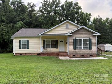 Charming single-story home with a well-maintained lawn, inviting front porch, and lovely curb appeal at 40287 Palmerville Rd, New London, NC 28127
