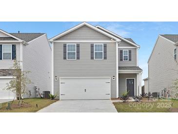 Charming two-story home featuring a two-car garage and gray siding, perfect for modern living at 1043 20Th Avenue Se Loop, Hickory, NC 28602