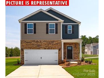Charming two-story home with a brick facade, attached two car garage and well-maintained lawn at 12020 Zazu Way, Charlotte, NC 28215