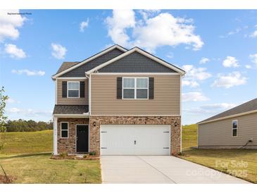 New two-story home featuring a two car garage, brick and siding exterior, and a well manicured front yard at 219 Parker Claire Ln, Kings Mountain, NC 28086