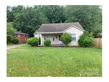 Charming single-story home featuring a cozy front porch and lush, verdant landscaping at 2722 Eastway Dr, Charlotte, NC 28205