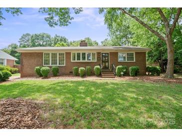 Charming brick home with a well-manicured lawn and lush landscaping in a desirable neighborhood at 3612 Trent St, Charlotte, NC 28209