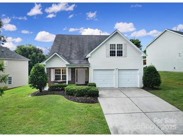 Charming two-story home with a well-manicured lawn, a two-car garage, and traditional architectural details at 3908 Parkers Ferry Rd, Fort Mill, SC 29715