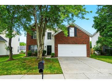 Charming two-story brick home features a well-manicured lawn and inviting curb appeal at 4982 Bentgrass Run Dr, Charlotte, NC 28269