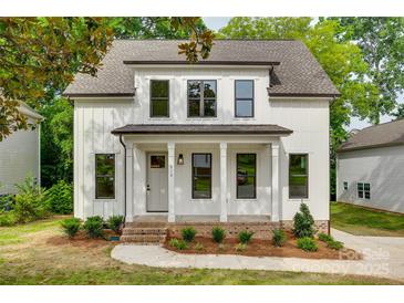 Charming two-story home with white siding, black trim, and a welcoming front porch at 513 Sacco St, Belmont, NC 28012